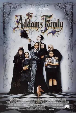 A family, dressed in black and white, pose together for a photo