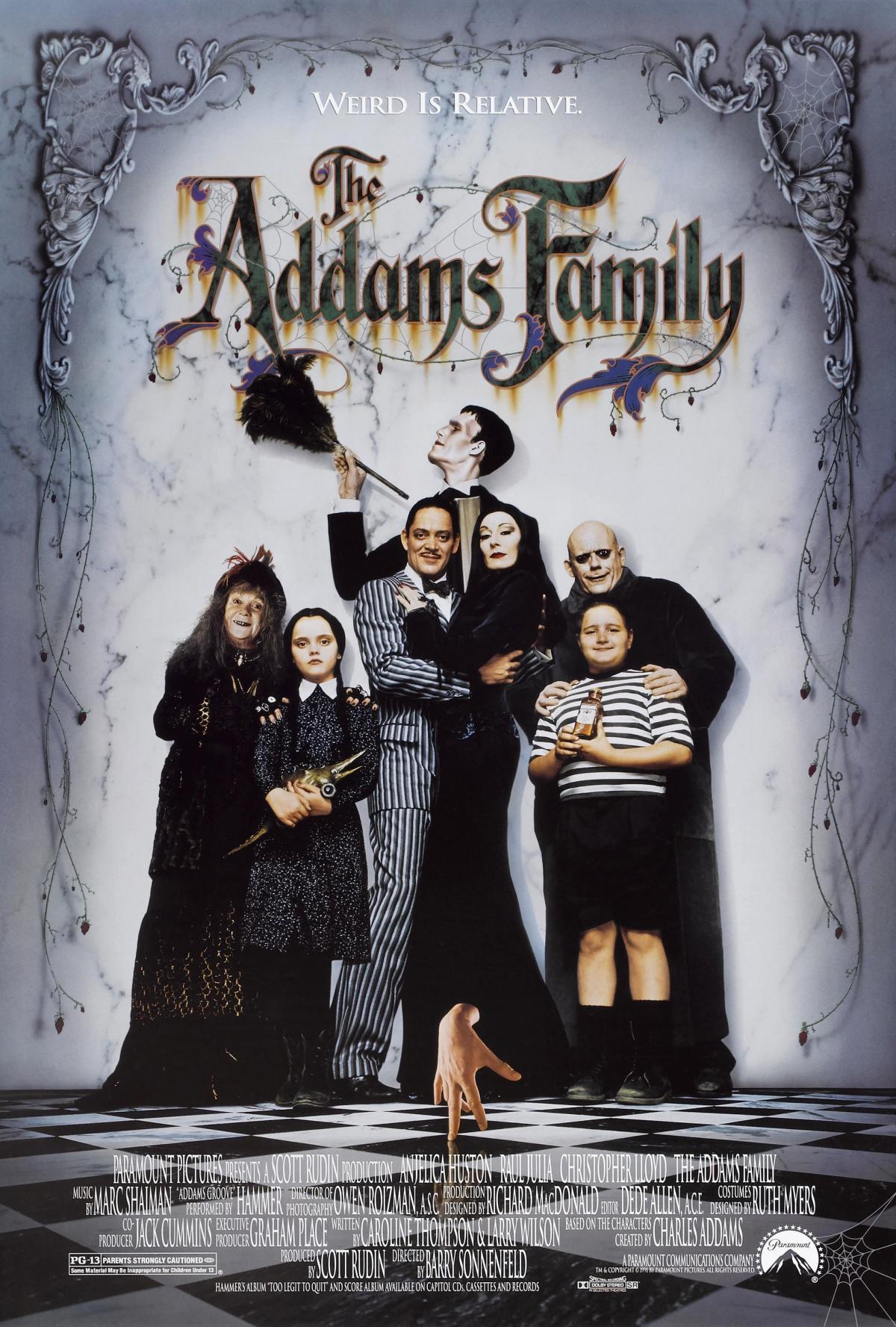 A family, dressed in black and white, pose together for a photo